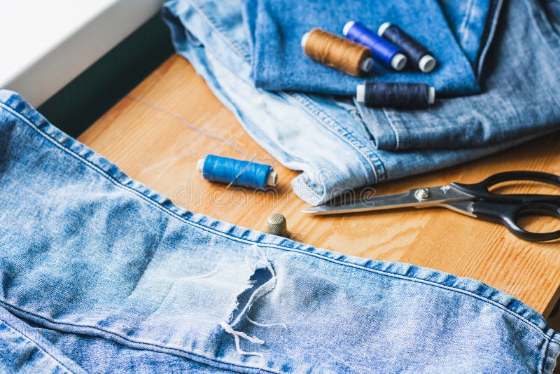 Premium Photo  Handicraft, clothing repair. ripped blue jeans