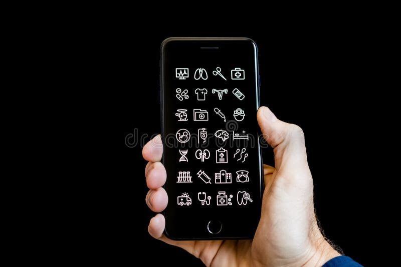 Handinnehav en Smartphone med vård- och medicinska symbolsApps på skärmen fotografering för bildbyråer Handinnehav en Smartphone med vård- och medicinska symbolsApps på skärmen fotografering för bildbyråer