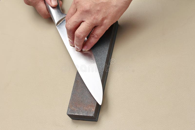 Handle the Knife To Make a Sharp Knife with a Whetstone. Stock Image