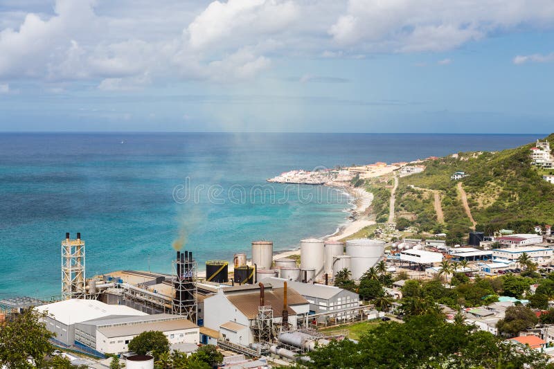 A view of bay on St Martin from hill with sugar factory on coast. A view of bay on St Martin from hill with sugar factory on coast