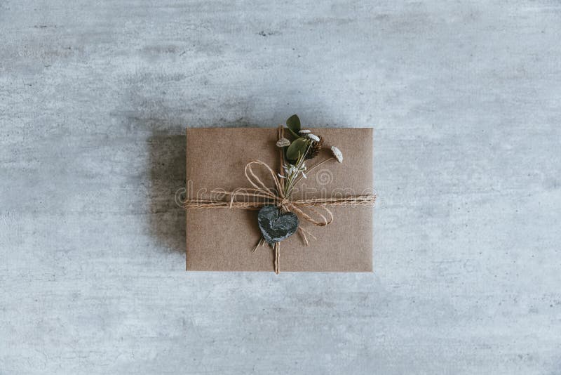 Handmade christmas gift or present box wrapped in kraft paper. T