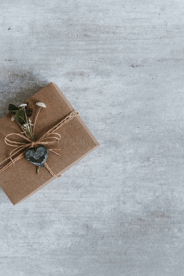 Handmade christmas gift or present box wrapped in kraft paper. T
