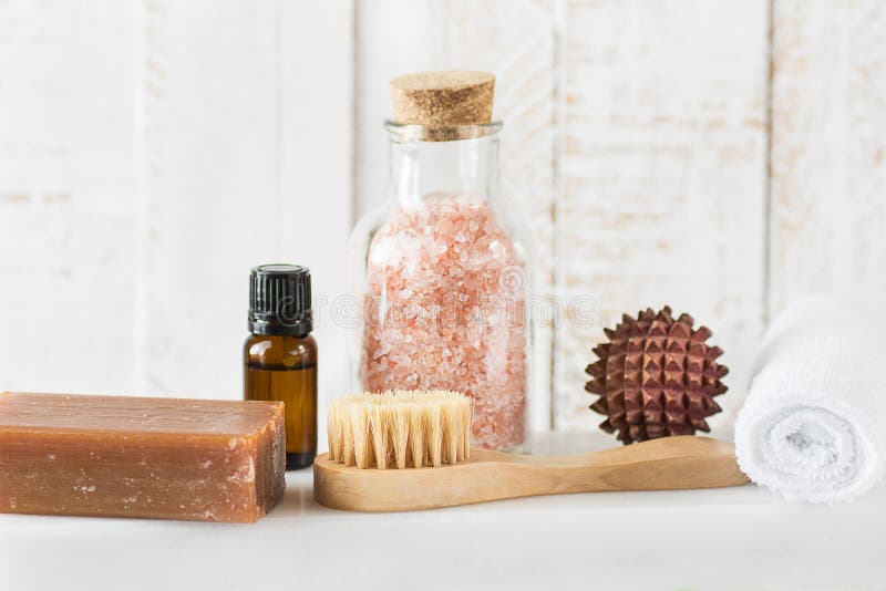Handmade Coal Tar Soap Pink Himalayan Salt Essential Oil Towel Brush Sandal Wood Massage Ball on White Marble Background. Spa stock photo Handmade Coal Tar Soap Pink Himalayan Salt Essential Oil Towel Brush Sandal Wood Massage Ball on White Marble Background. Spa stock photo