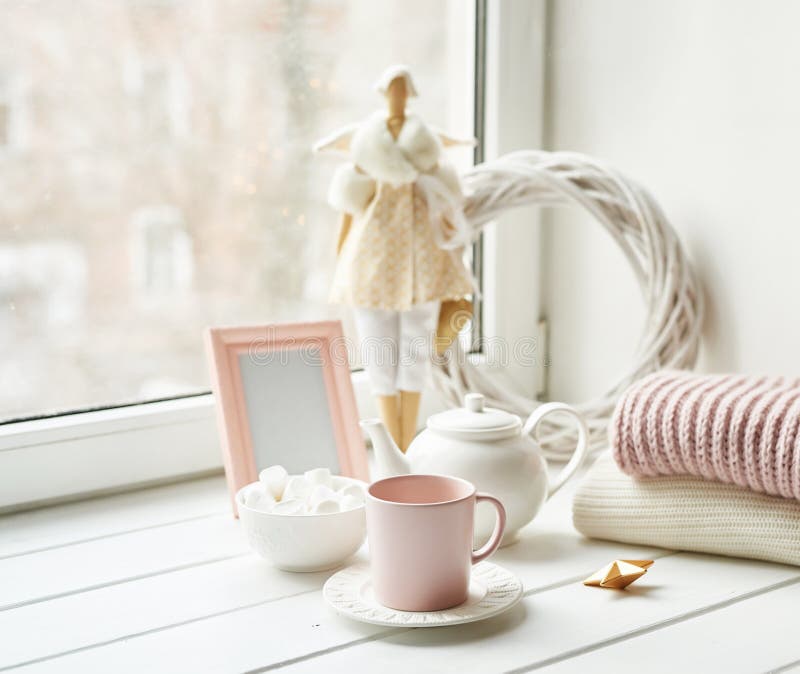 Handmade doll with tea set and marshmallows near window. Cozy winter morning breakfast. Christmas concept and mood. Postcard royalty free stock image Handmade doll with tea set and marshmallows near window. Cozy winter morning breakfast. Christmas concept and mood. Postcard royalty free stock image