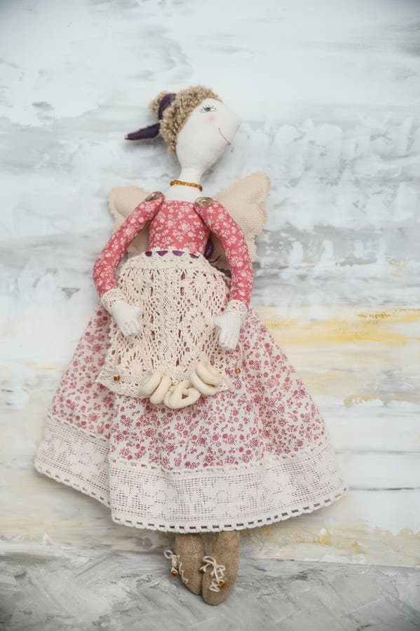 Handmade toy blonde angel in red lace dress bakery royalty free stock photography Handmade toy blonde angel in red lace dress bakery royalty free stock photography