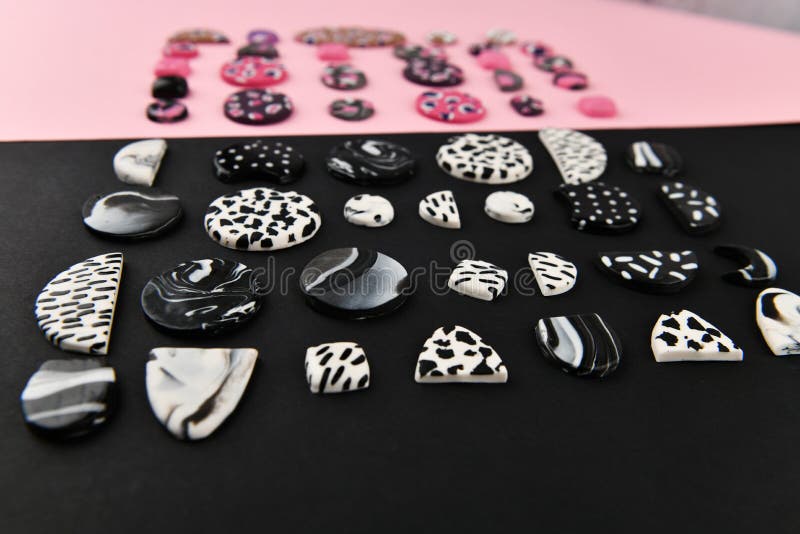 A Product From Polymer Clay. Black And White Polymer Clay. Hand Sculpting,  Product For Earrings On A Black Background. View From Above. Black And  White Jewelry Earrings. Handmade Polymer Clay Jewelry. Stock