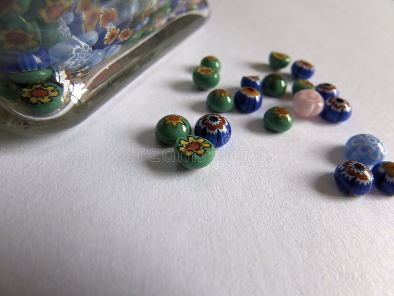 Handmade Multicolored Glass Beads on White Surface with Soft Light