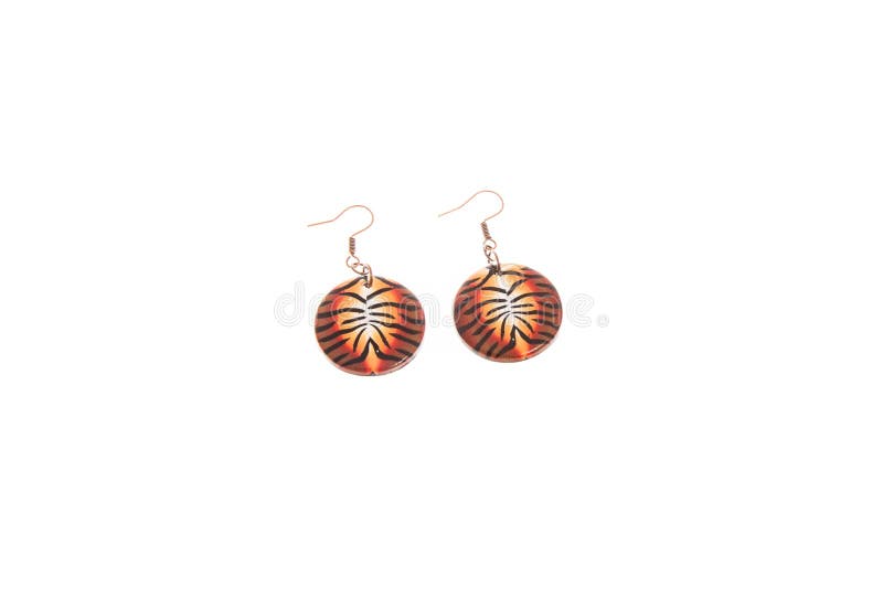 Handmade polymer clay earrings with tiger skin patterns isolated on white background. Female accessories, decorative ornaments and jewelry. Fashion and style concept