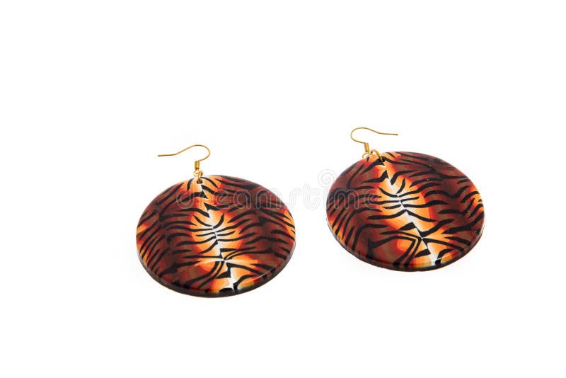 Handmade polymer clay earrings with tiger skin patterns isolated on white background. Female accessories, decorative ornaments and jewelry. Fashion and style concept