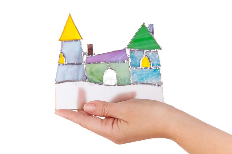 Handmade stained glass colorful castle in hand isolated o