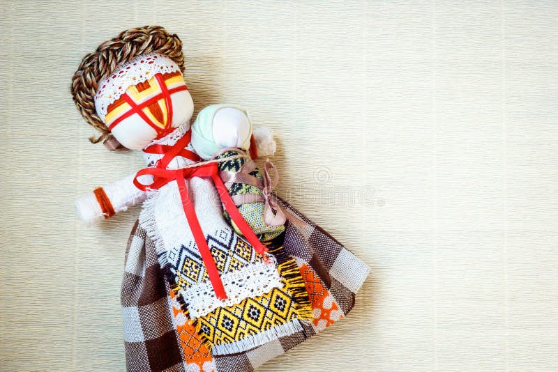 Handmade textile doll, rag doll  Motanka  in ethnic style, ancient culture folk crafts tradition of Ukraine.