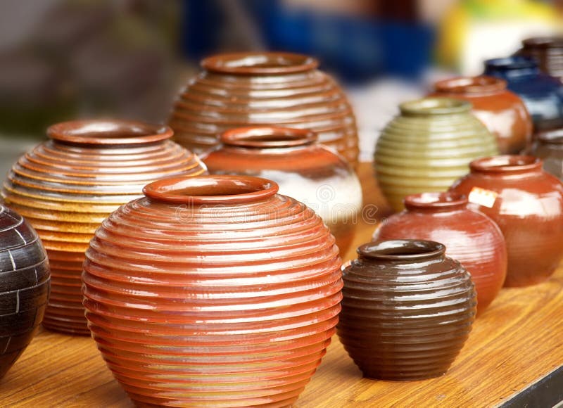 Glazed ceramics are for sale at an outdoor market. Glazed ceramics are for sale at an outdoor market