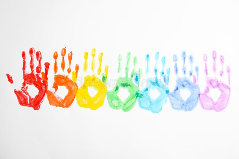 Handprints made with bright paints on background, top view. Rainbow colors