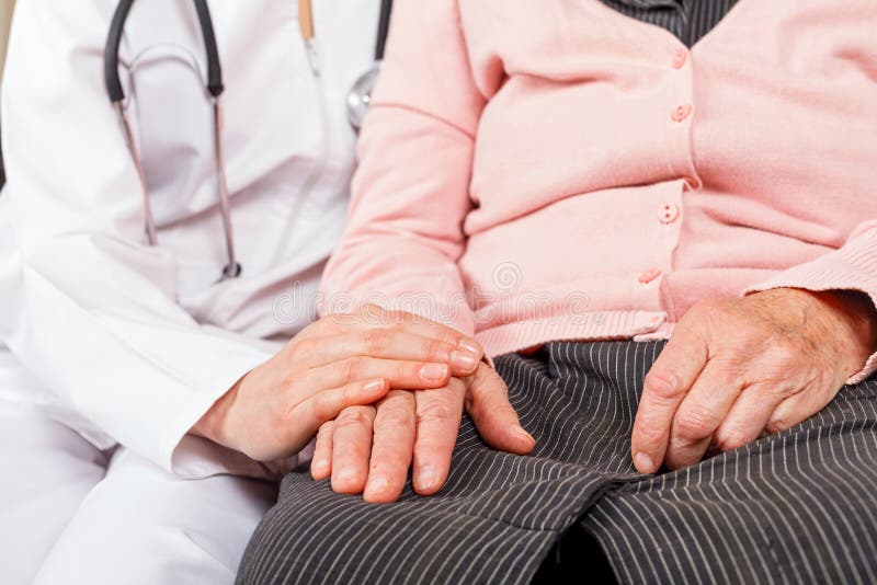 Young doctor giving helping hands for elderly woman. Young doctor giving helping hands for elderly woman