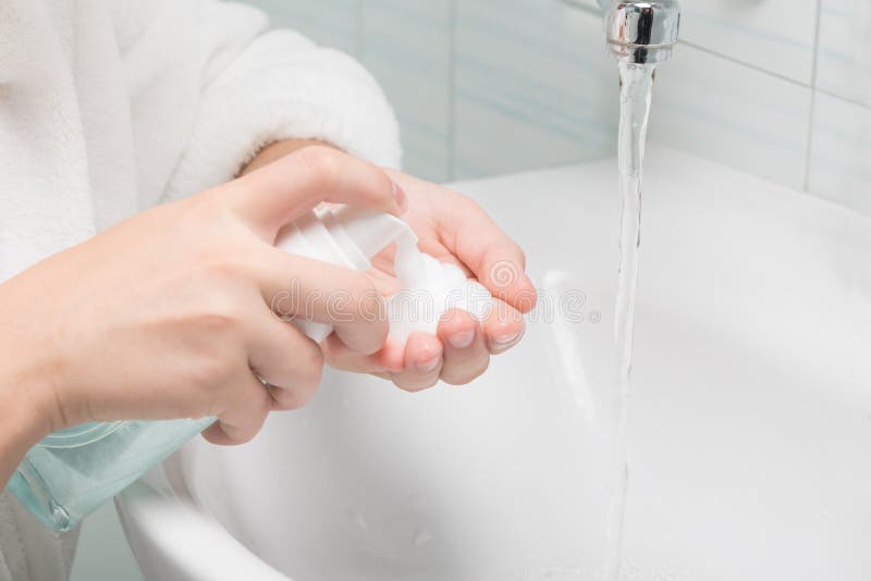 Hands Apply Face Wash Foam in the Bathroom, Closeup Stock Photo