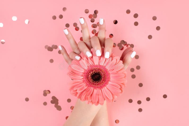 Hands of a beautiful woman on a colorful background. Delicate palm with natural manicure, clean skin. Light pink nails stock photo Hands of a beautiful woman on a colorful background. Delicate palm with natural manicure, clean skin. Light pink nails stock photo