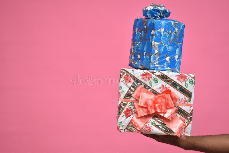 hands only of a black person holding up two gift boxes close up stock images hands only of a black person holding up two gift boxes close up stock images