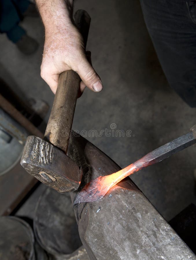 Hands of blacksmith by the work