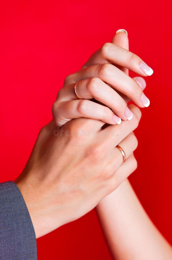 Hands of a bride and a groom