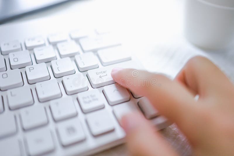 Hands of business woman Pressing enter button on computer keyboard stock photography