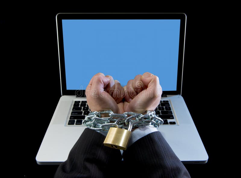 Hands of businessman addicted to work bond with chain to computer laptop in workaholic royalty free stock photo