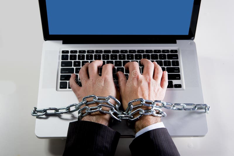 Hands of businessman addicted to work bond with chain to computer laptop in workaholic royalty free stock image