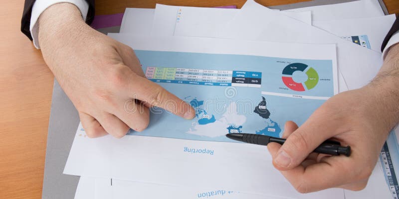 hands of a businessman analyzing his international sales stock images hands of a businessman analyzing his international sales stock images