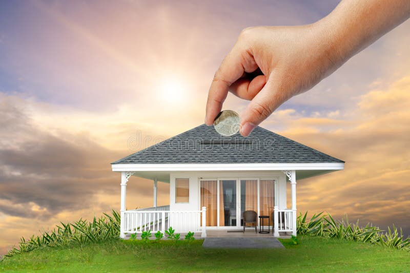 The hands of a businessman hold money and the other hand holds a house. The idea of saving money to buy a house stock images The hands of a businessman hold money and the other hand holds a house. The idea of saving money to buy a house stock images