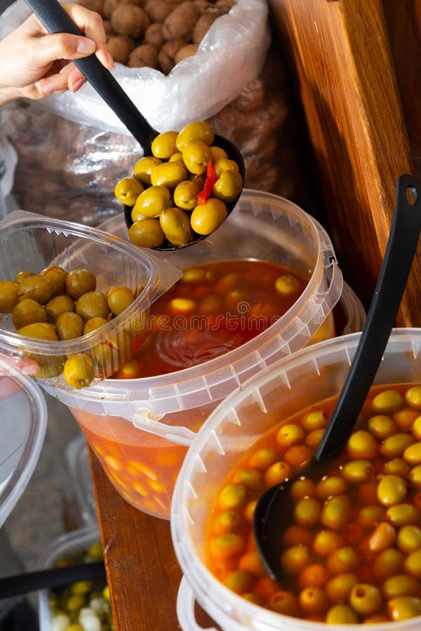 Hands of Buyer Pouring Pickled Olives by Weight into Plastic Container Stock Photo Image of