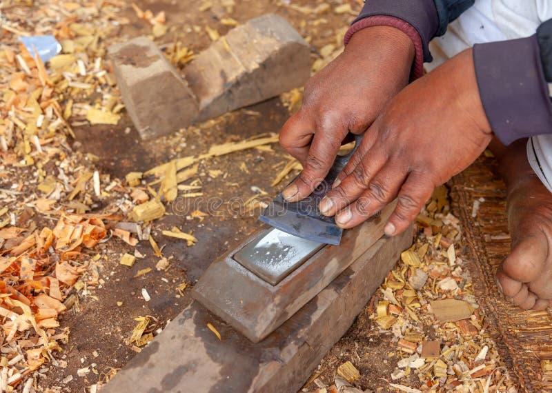 Hands of a carpenter sharpening his tools. stock images