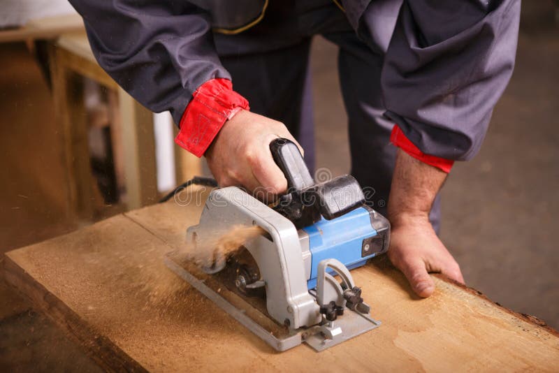 Hands carpenter working with a circular saw stock photo