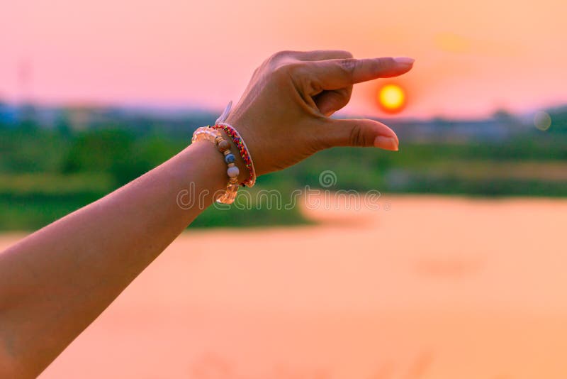 time until sunset with hand time until sunset with hand