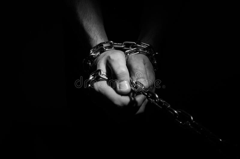 Hands are Chained in Chains Isolated on Black Background Stock Image