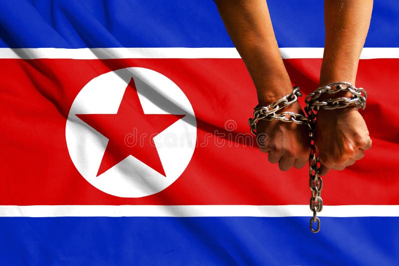 The hands of the chains against the background of the flag of North Korea, DPRK royalty free stock image The hands of the chains against the background of the flag of North Korea, DPRK royalty free stock image