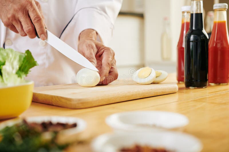 Chef cutting chicken eggs stock photo. Image of ingredient 174265096