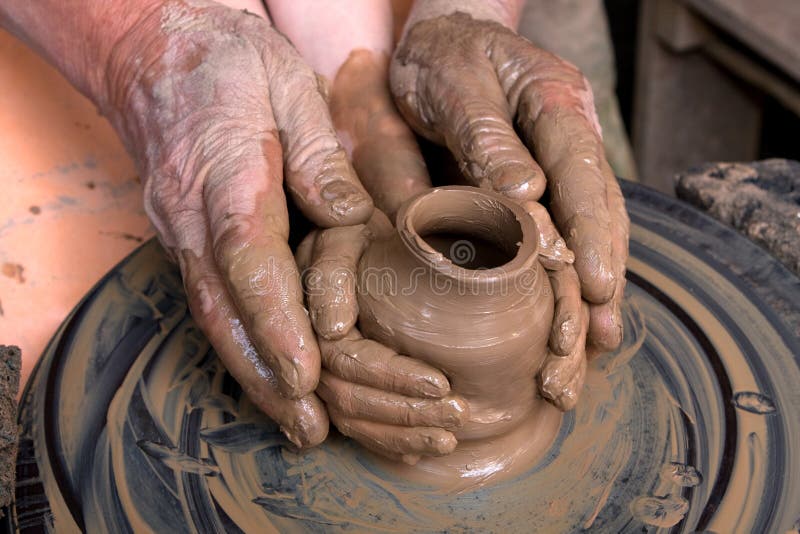 hands of the child and adult molded ceramic vesse