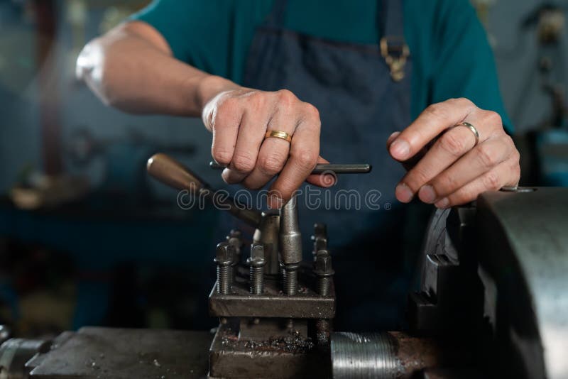 Hands close-up of Asian craftsmen, skilled craftsmen, skillfully mastering lathes, in a small family-owned factory stock images