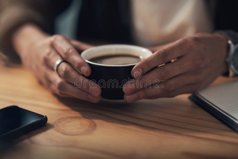 Hands, coffee and man at desk, relax and professional with espresso, calm and herbal tea. Closeup, person and royalty free stock image