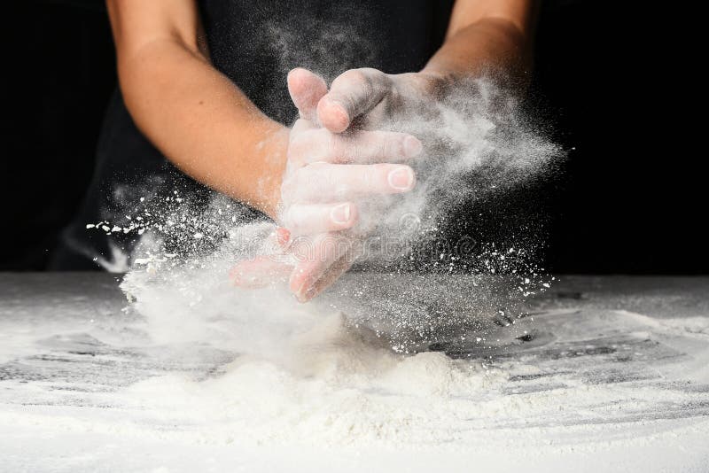 Hands of the cook splash clap with flour