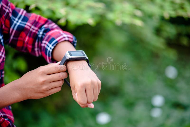 Hands and digital watches of boys Watch the time in the wrist.