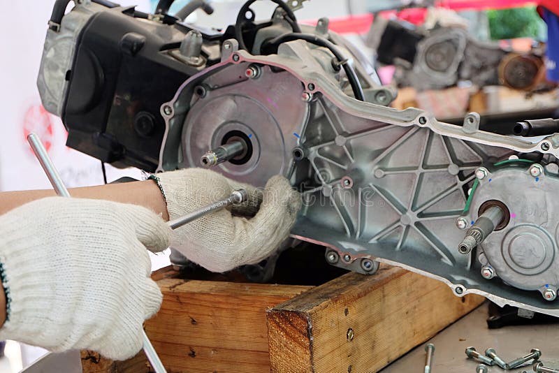 Hands of Disassembly Kit Motorcycle in Repair Service. Stock Photo