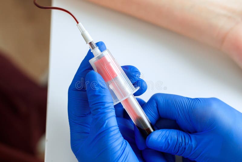 Hands of a Doctor Taking Blood Samples Using a Tube Holder Stock Photo