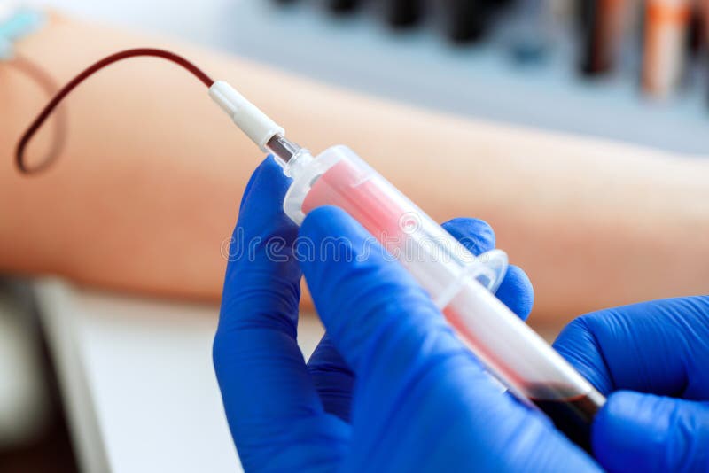 Hands of a Doctor Taking Blood Samples Using a Tube Holder Stock Photo