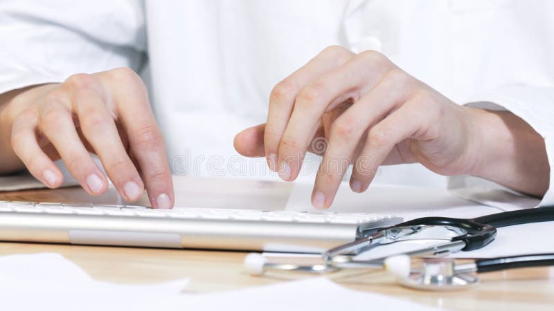 Doctor typing on computer stock video footage