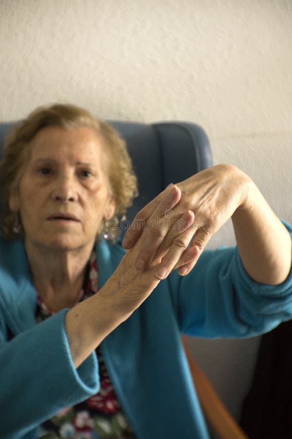 Hands of elderly woman with alzheimer doing massage