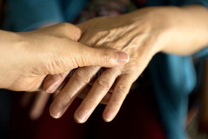 Hands of elderly woman with alzheimer doing massage