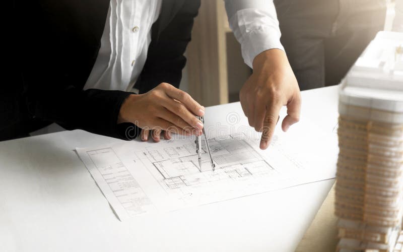 Hands of Engineers working on blueprint at a workplace, Construction and building concept stock image