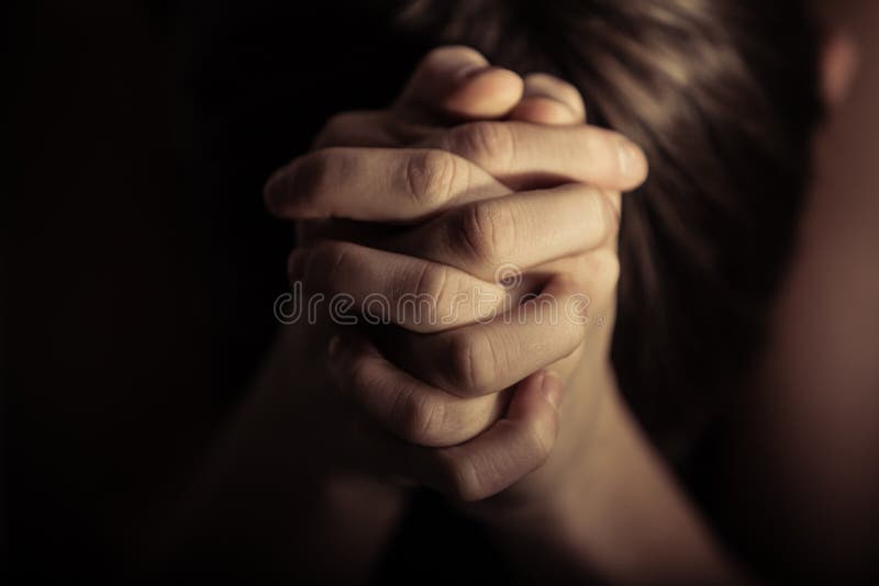 Hands folded together in prayer