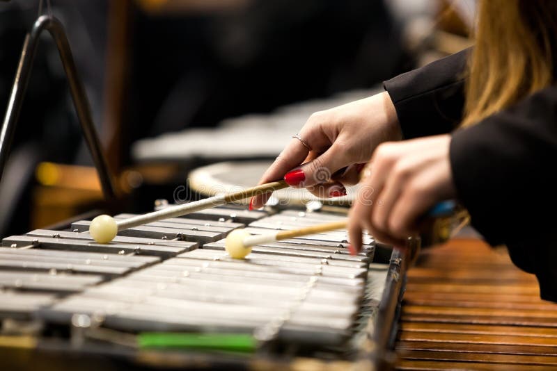 Hands of a girl playing a glockenspiel closeup