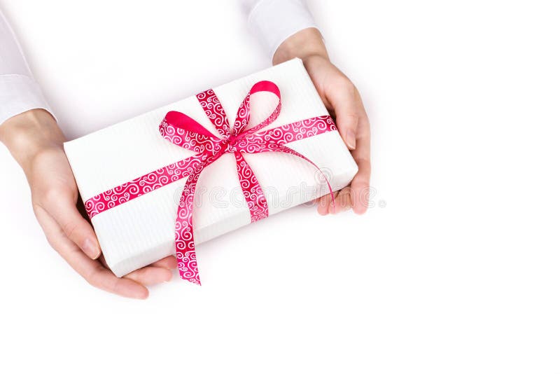 hands giving gift box with pink ribbon on white background